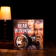 The box for the Rear Window board game against a dark backdrop.